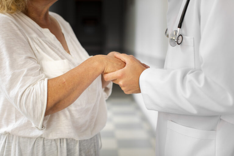 doctor-hands-holding-senior-woman-hands