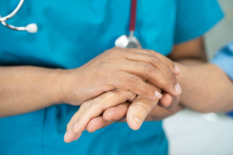 Doctor holding touching hands Asian senior or elderly old lady w
